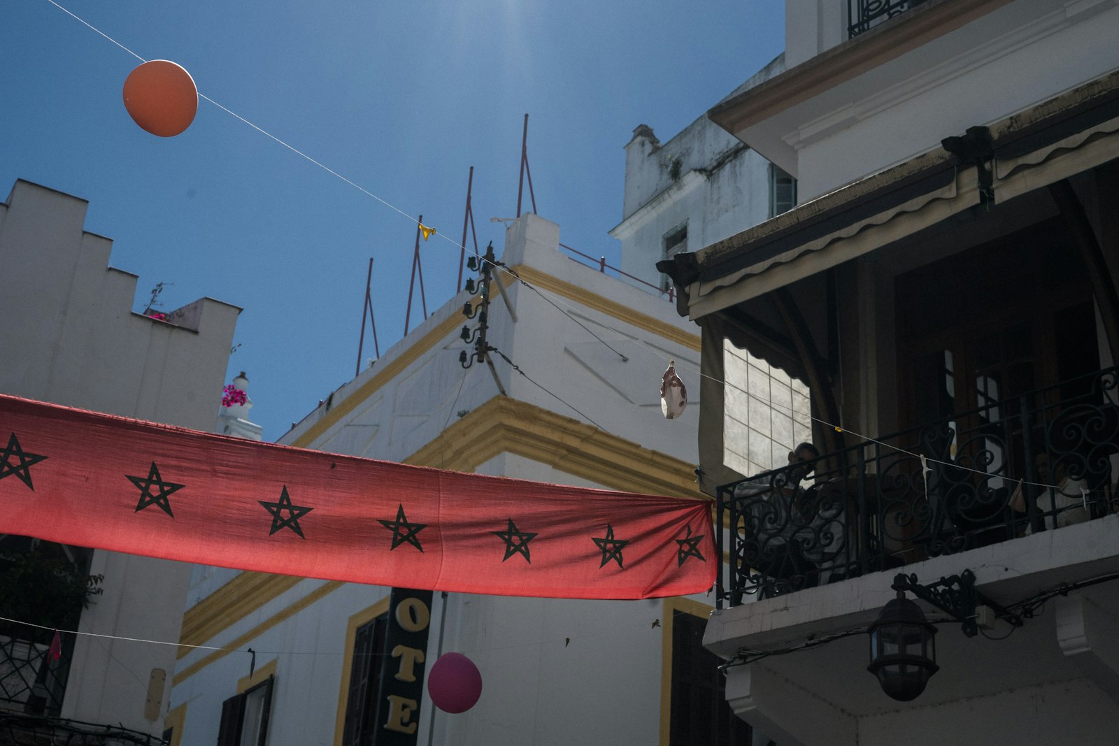 An orange ball is in the air near a building