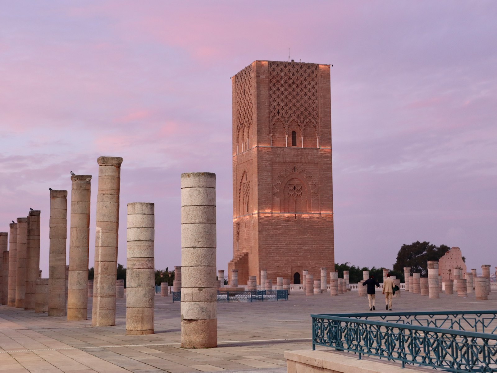 A group of pillars sitting next to a tall building