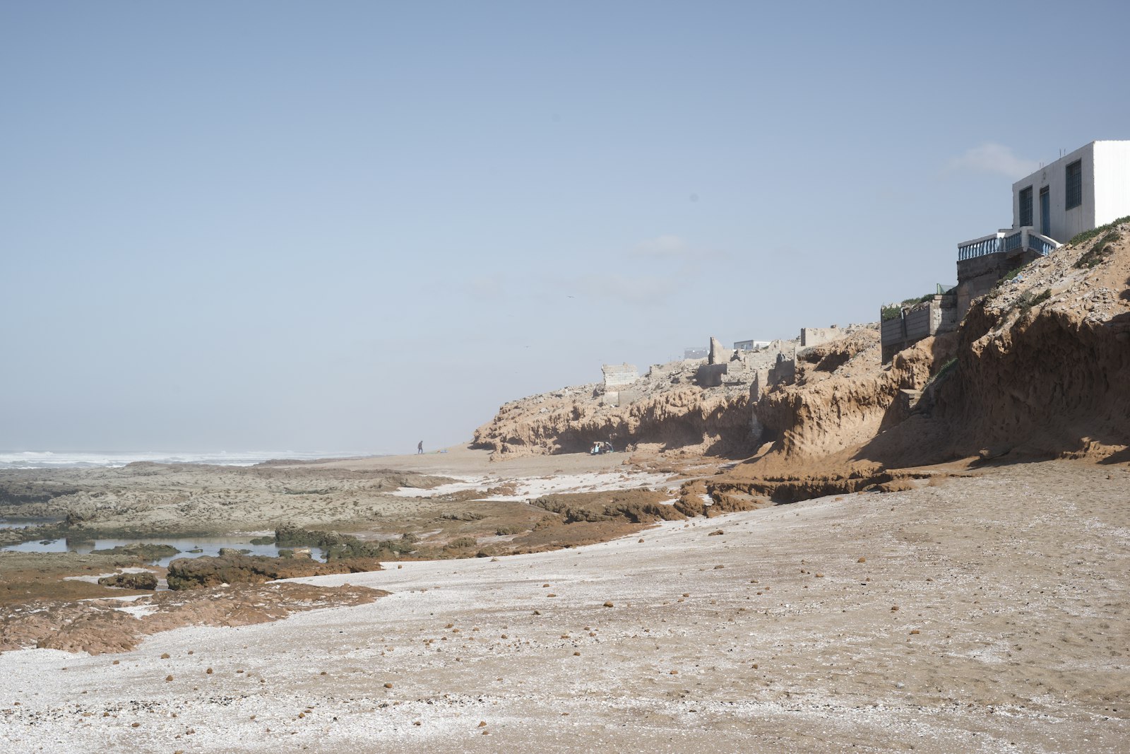 a sandy beach with a building on it