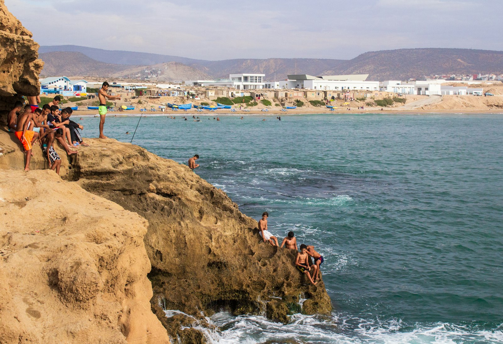 group of people climbing on cliff