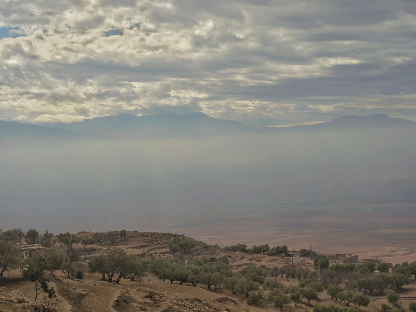 A man riding a horse on top of a dirt hill