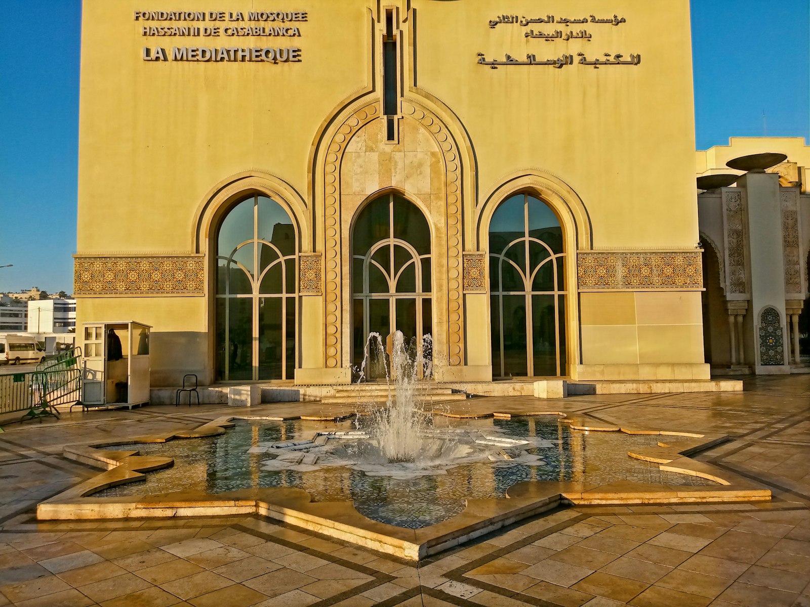 a large building with a fountain in front of it