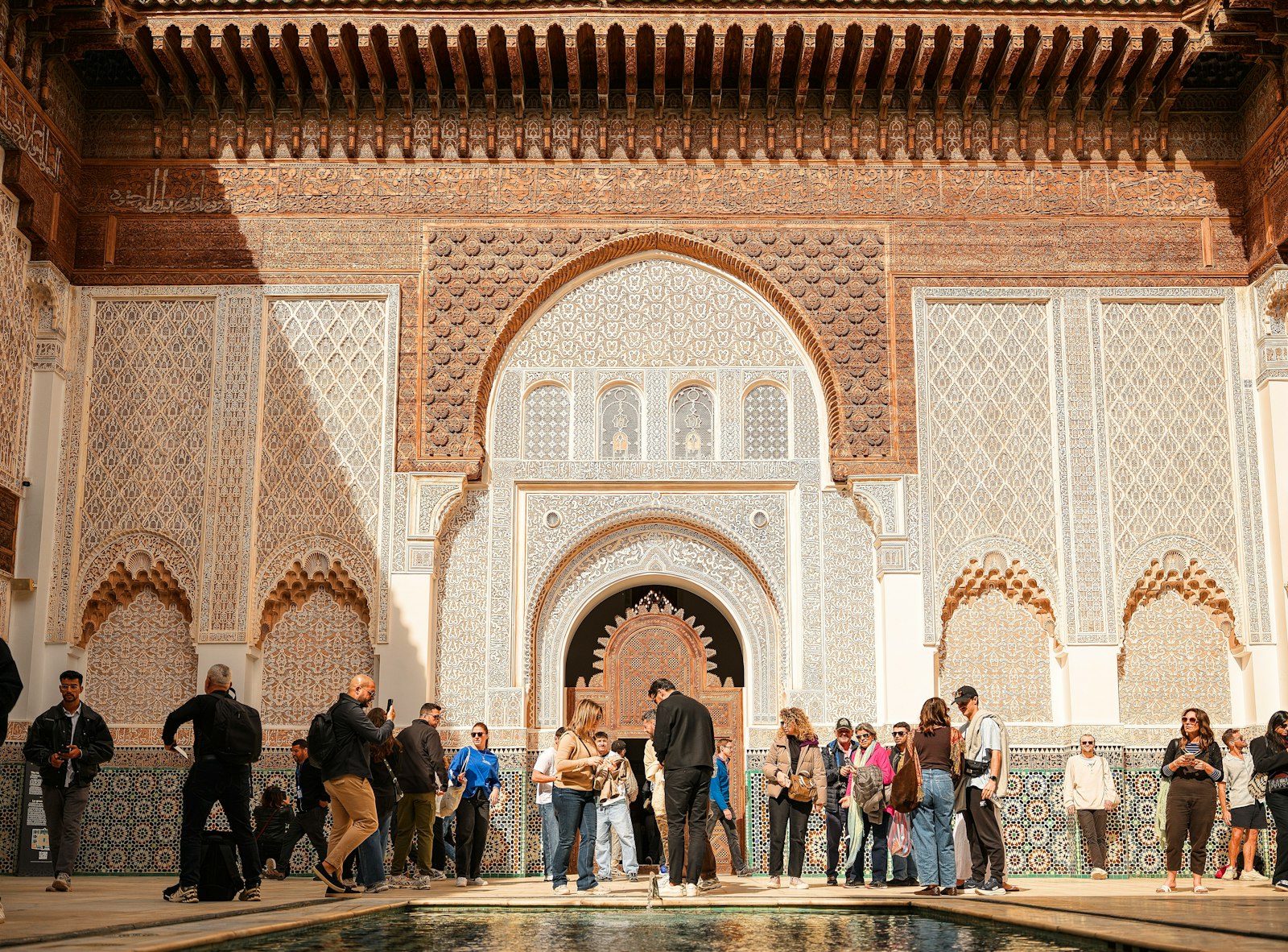 People gathered in a courtyard with ornate architecture.
