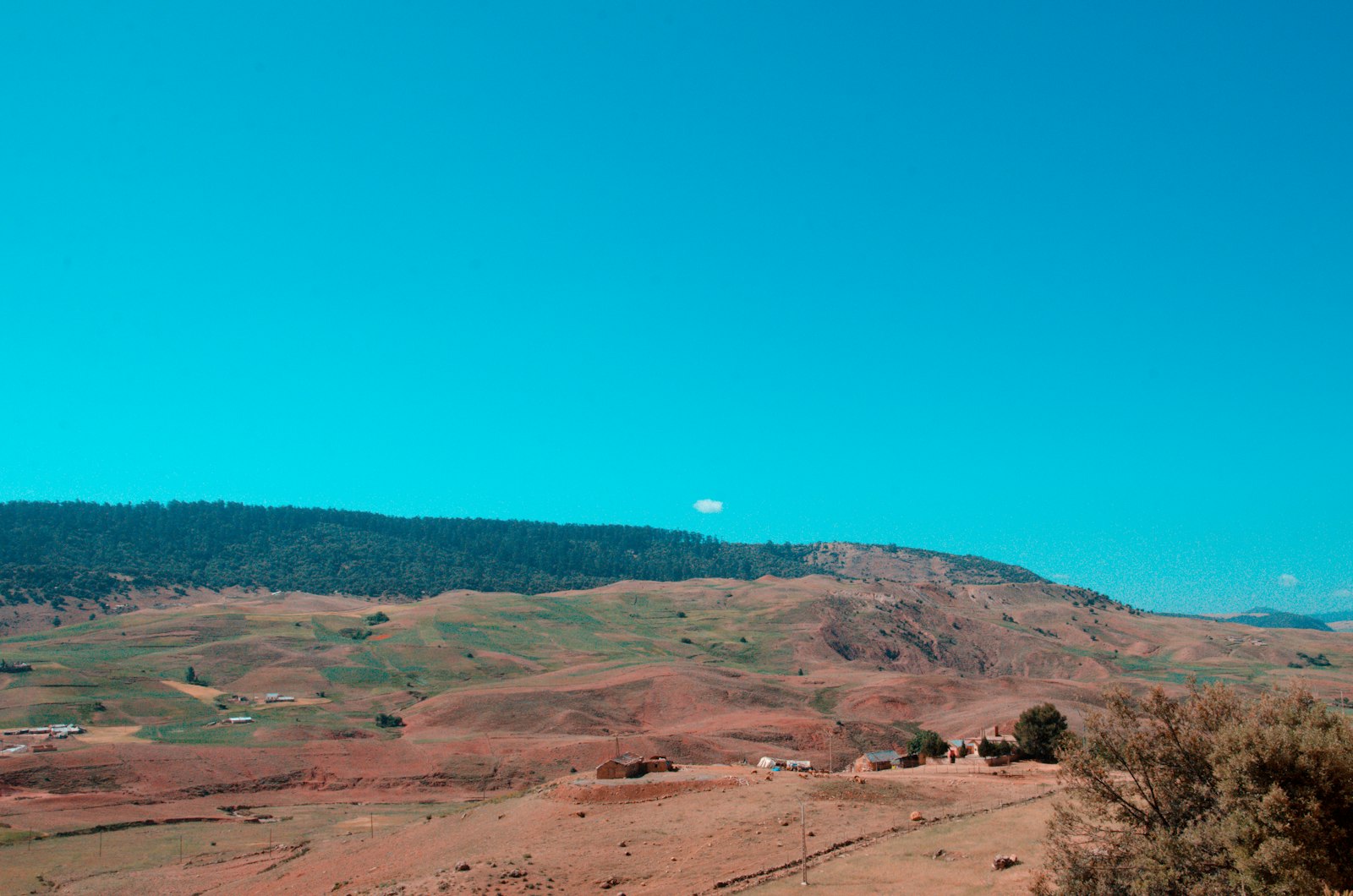 a view of a mountain range with a blue sky in the background