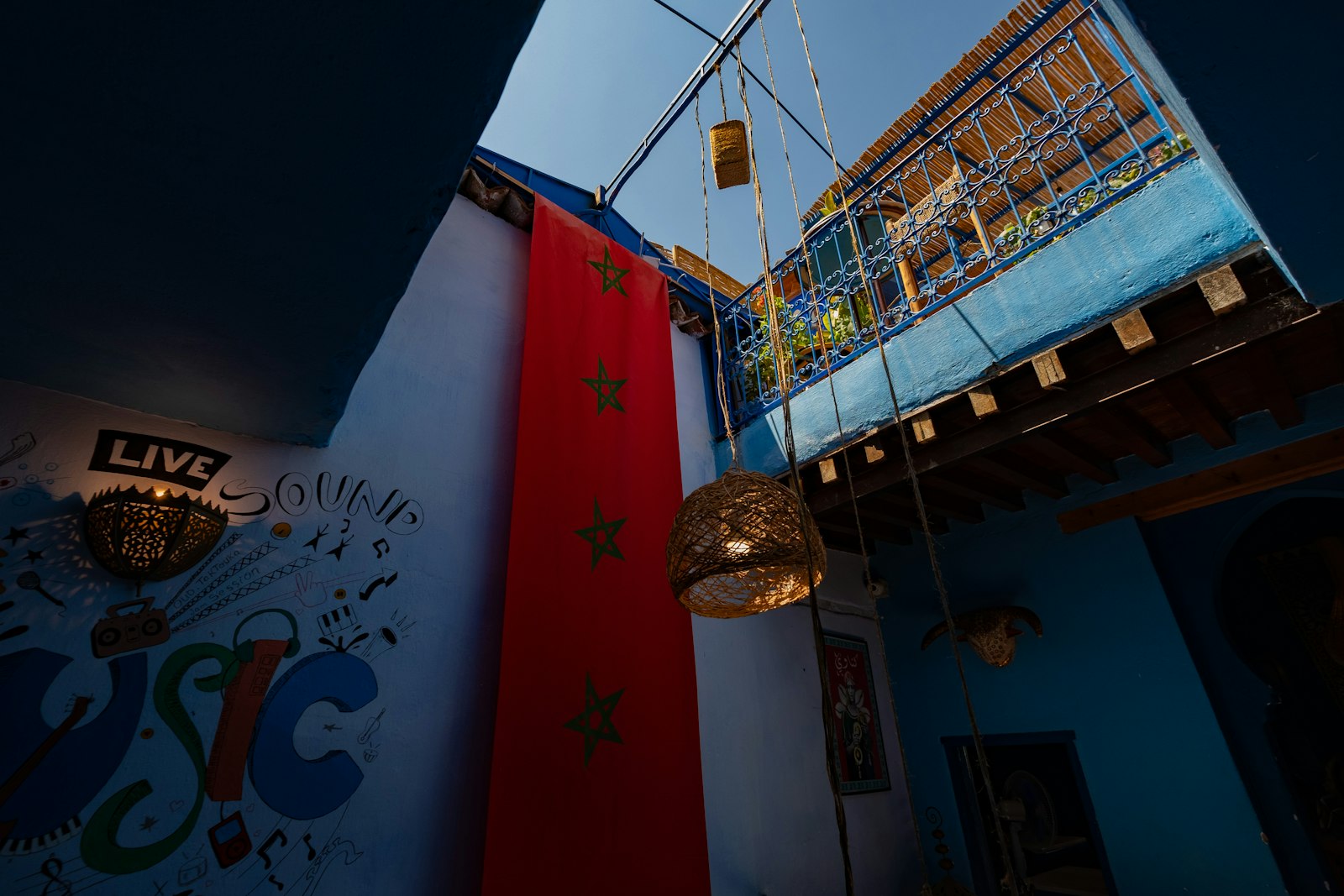 Blue building with red banner and hanging lights