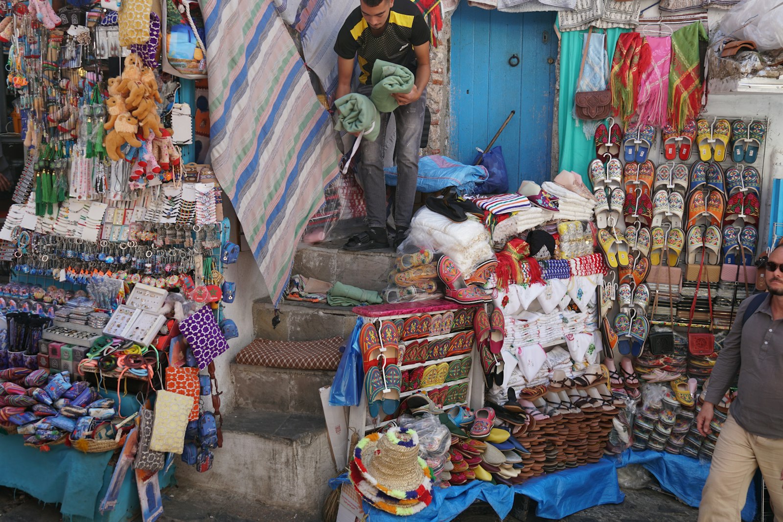 A bustling market stall with many colorful goods.