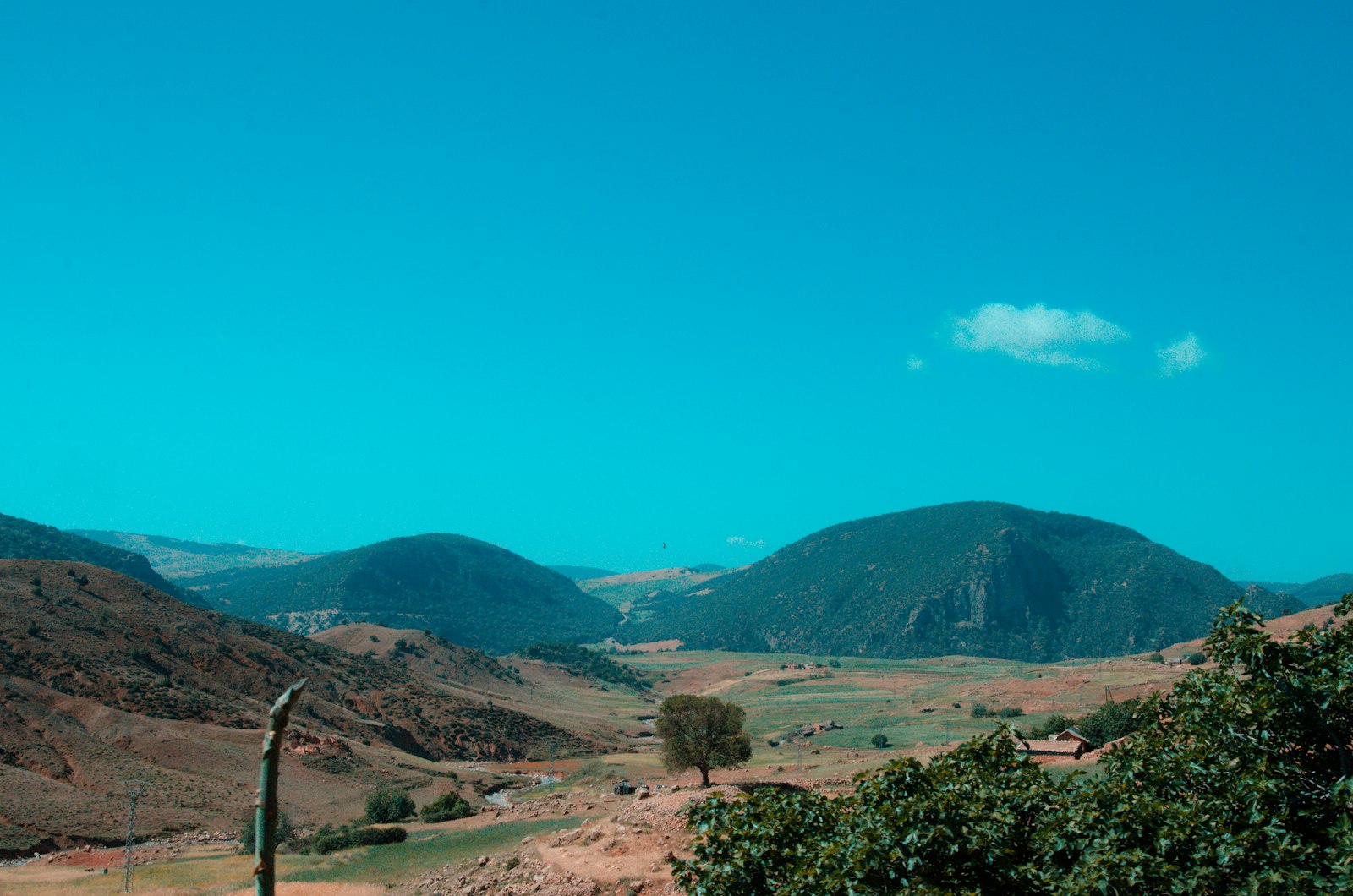 a view of a valley with mountains in the background