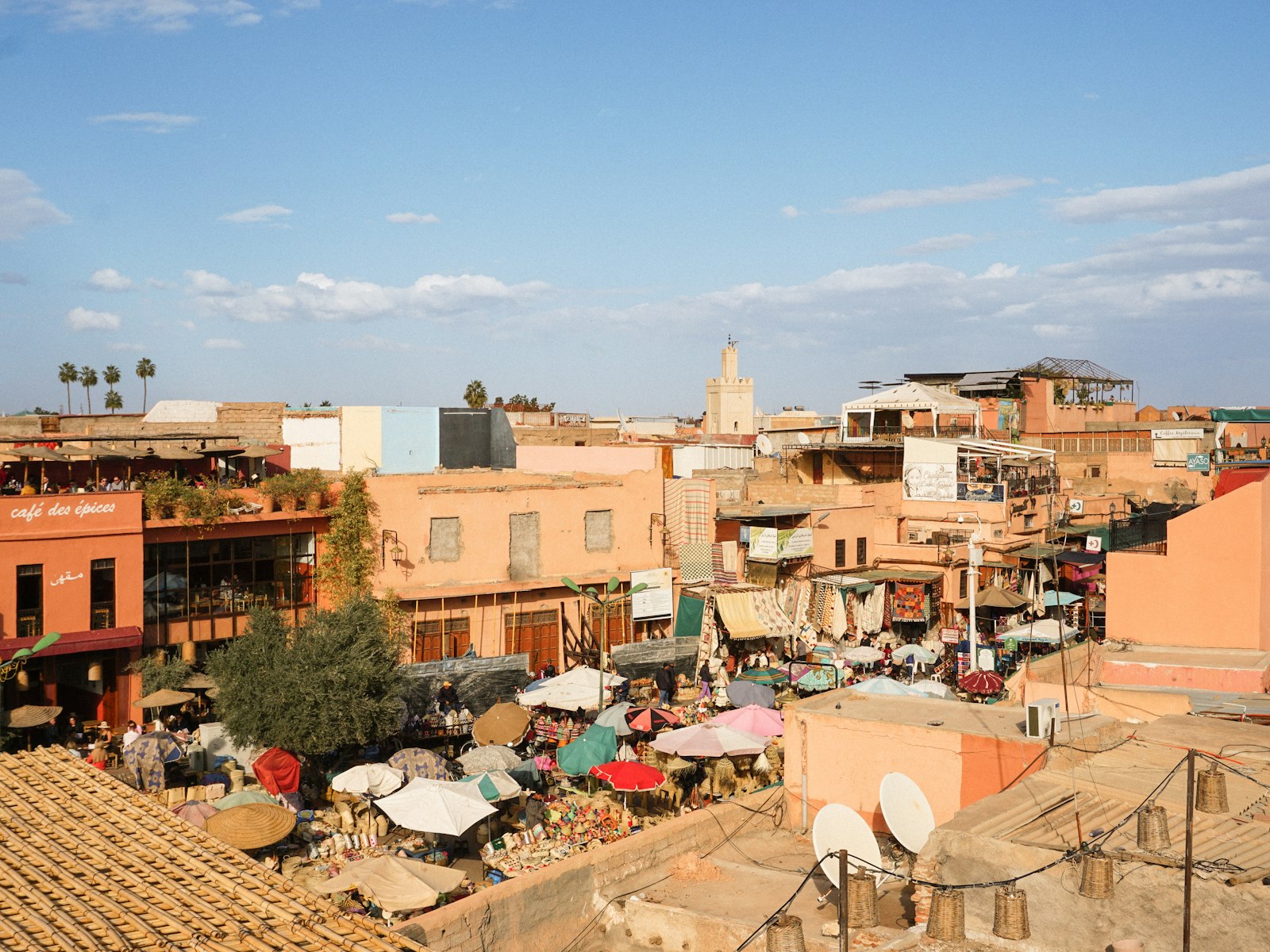a view of a city with lots of buildings and umbrellas